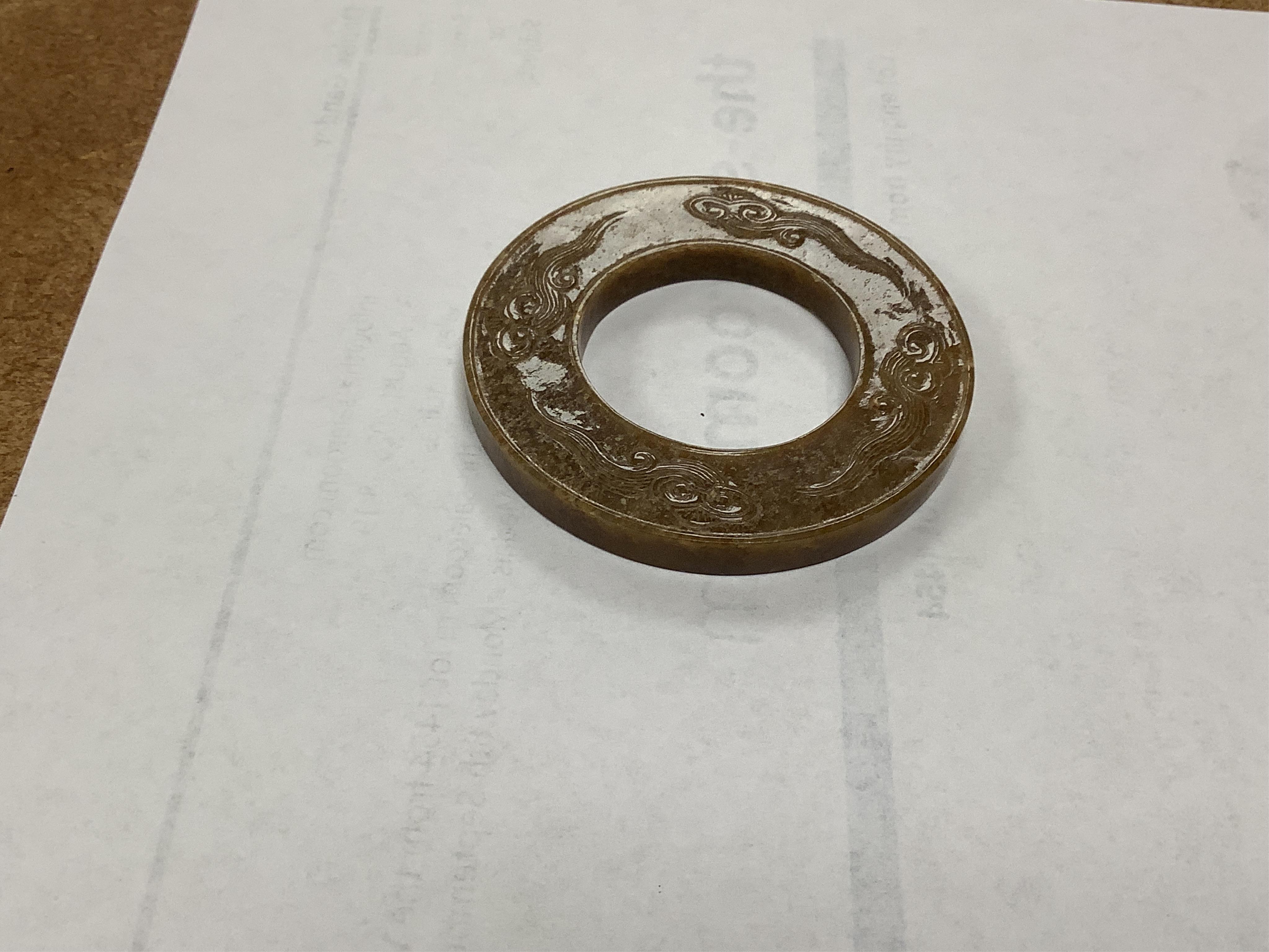 A Chinese russet jade dragon disc, 5.5cm diameter